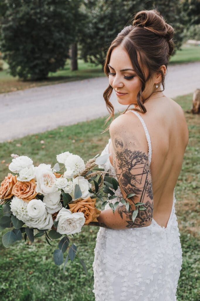 Bride holding her bouquet and looking over her shoulder during bridal portraits at Waupoos Estates Winery.