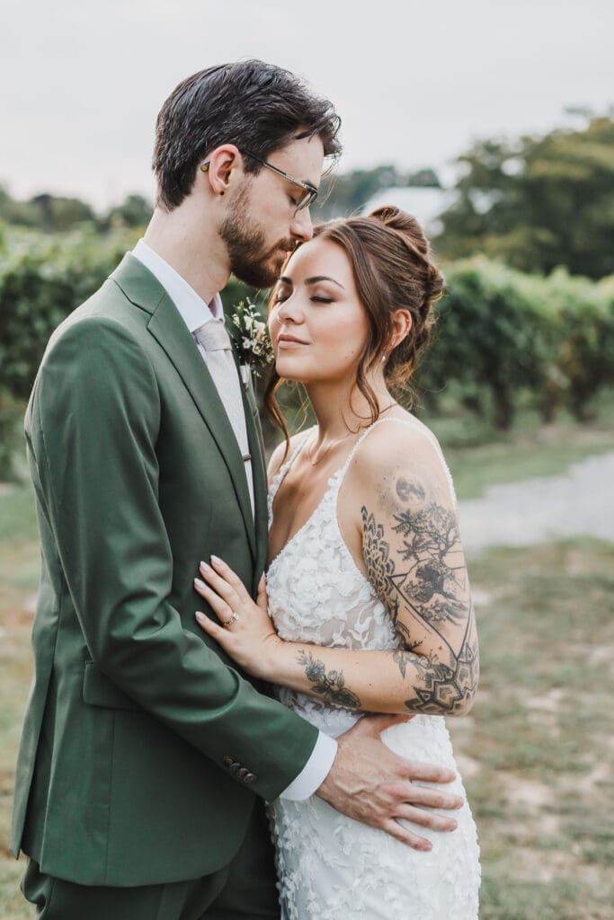 Bride and groom embracing during sunset portraits at Waupoos Estates Winery in Prince Edward County.