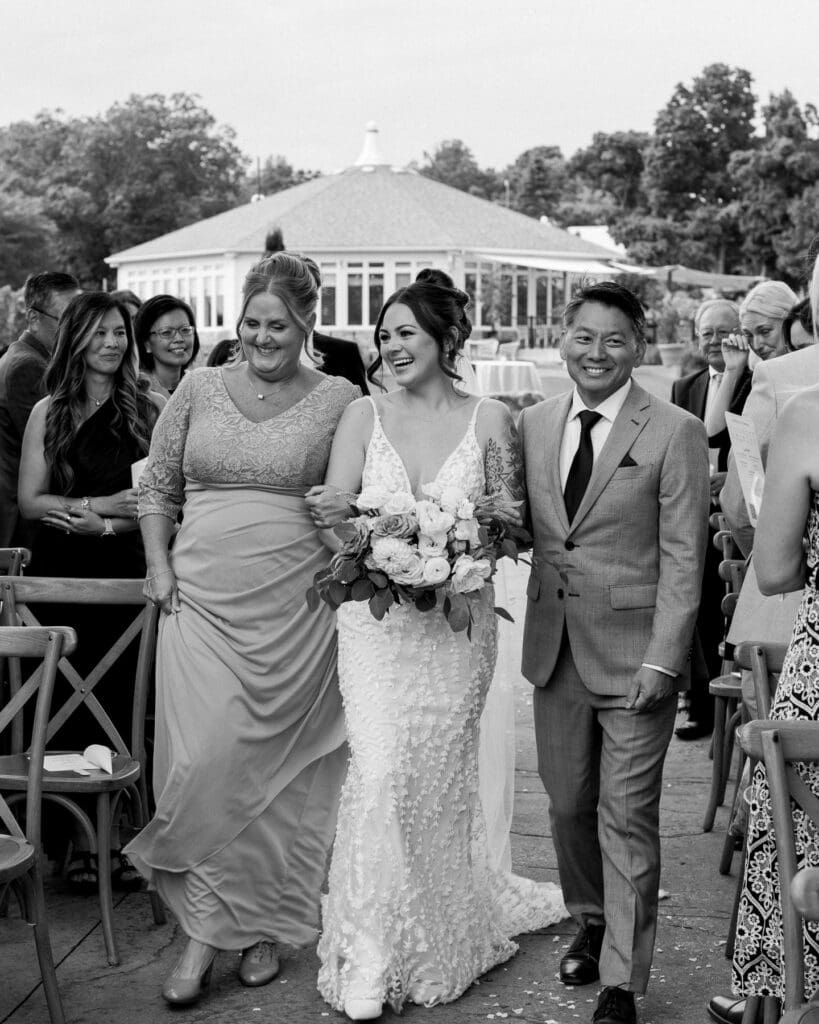 Midori walking down the aisle with her parents at Waupoos Estates Winery