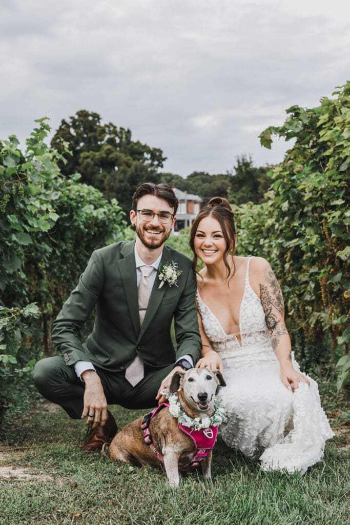 Midori and Joe posing with their dog at Waupoos Estates Winery wedding