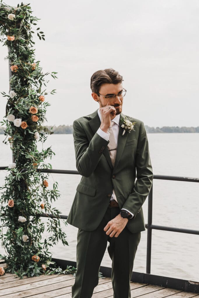 Groom waiting for his bride during the waterfront ceremony at Waupoos Estates Winery
