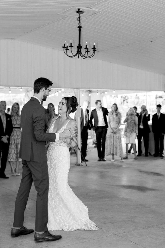 Bride and groom sharing their first dance surrounded by family and friends during their reception at Waupoos Estates Winery.
